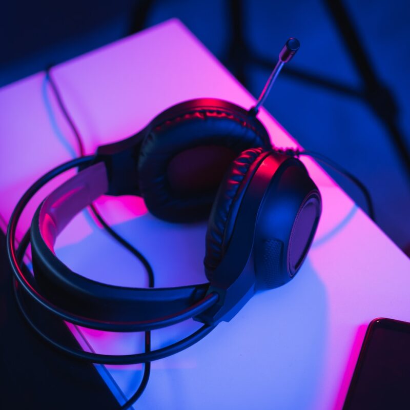 black and red corded headphones on white table